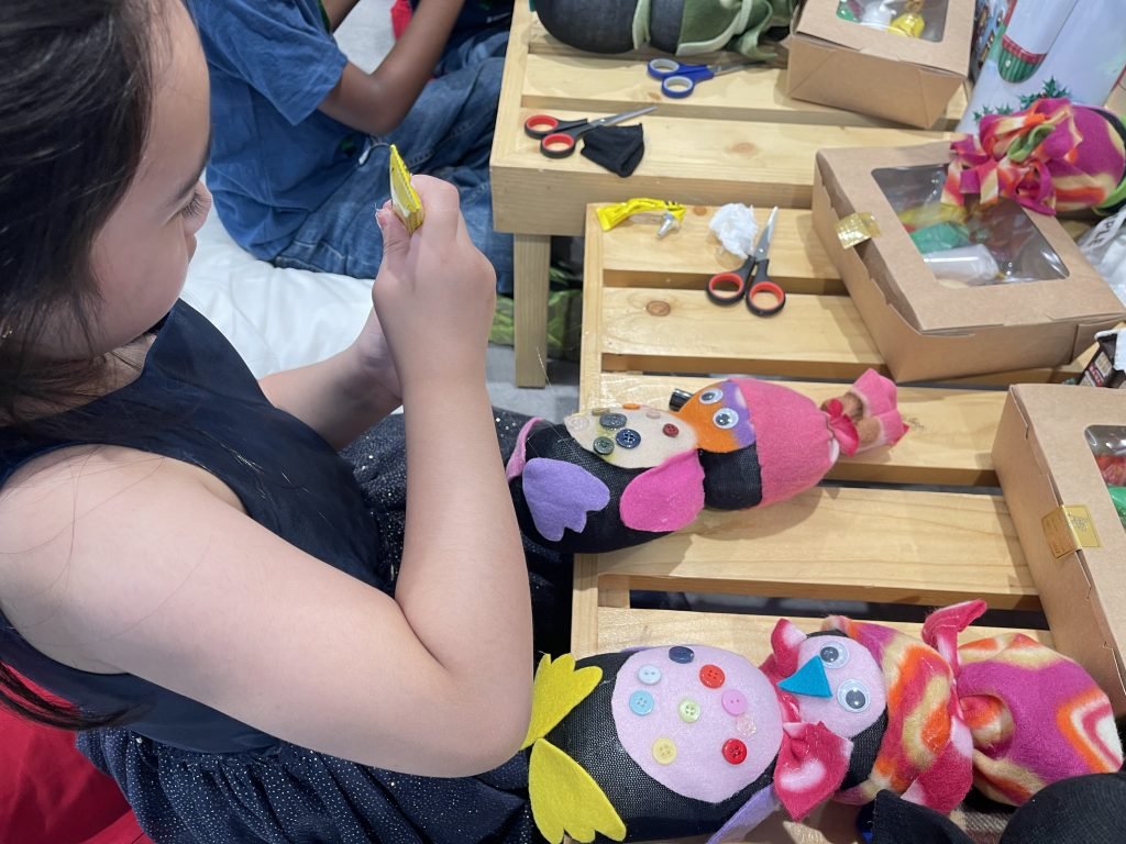 A lady busy in toy making activity