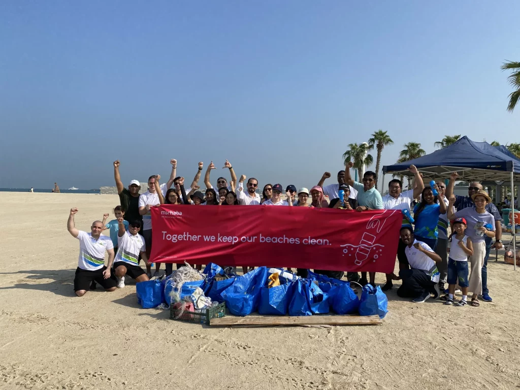 group of employees happily raises hand after doing enviornmental activities in dubai