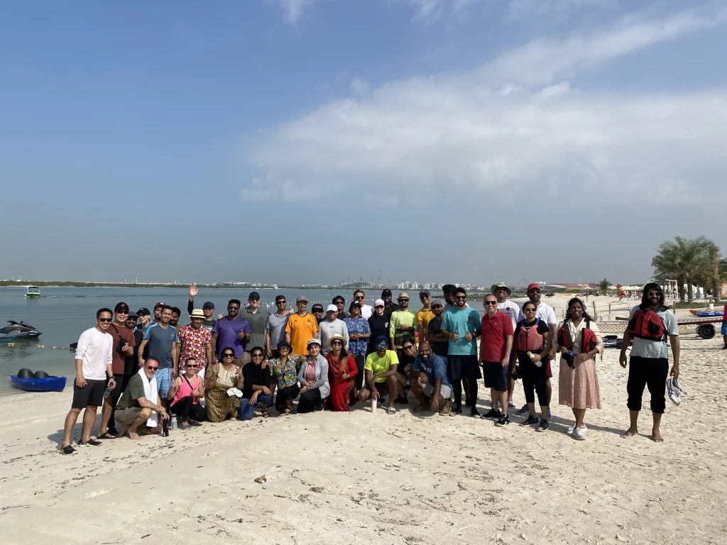 group of individual posing after doing beach clean up activity in uae