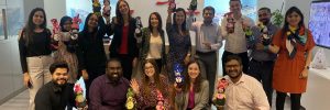 group of individuals poses with toys in their hands made by them