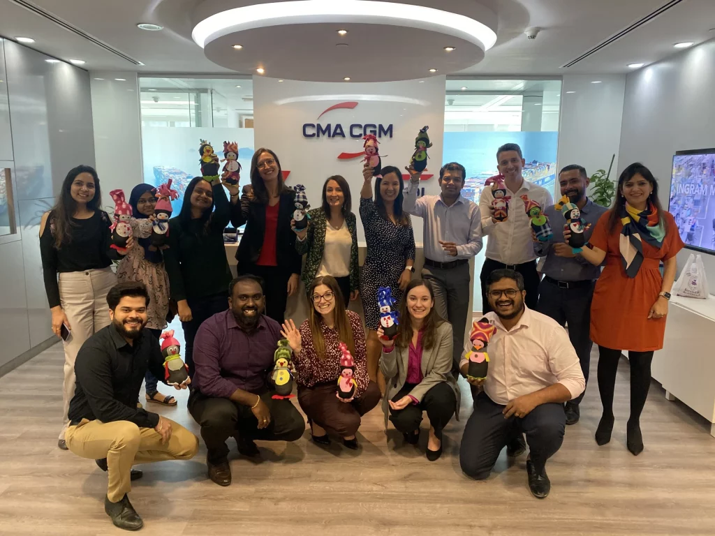 group of individuals poses with toys in their hands made by them