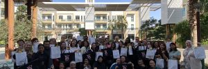 group of women happily posing after packing parcels to support children