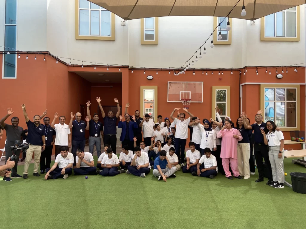 group of people raises hands by doing sustainable activities in dubai