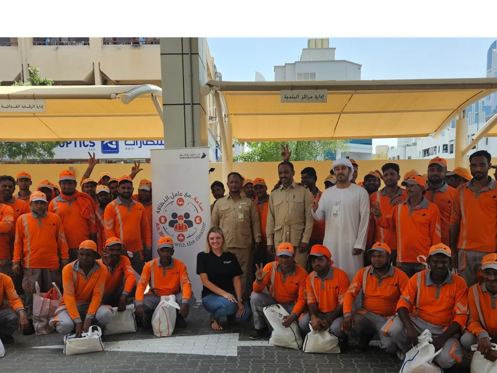 triple fast team posing while food distrubtion to workers in dubai
