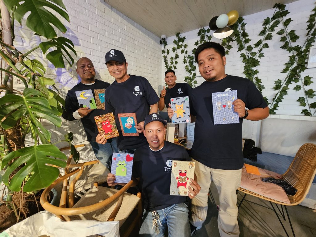 Men poses with hand made cards in their hand