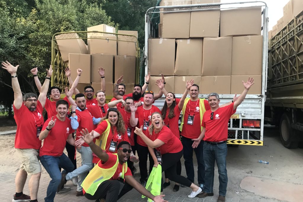 A group of employees happy after packing ramadan gifts for workers in dubai