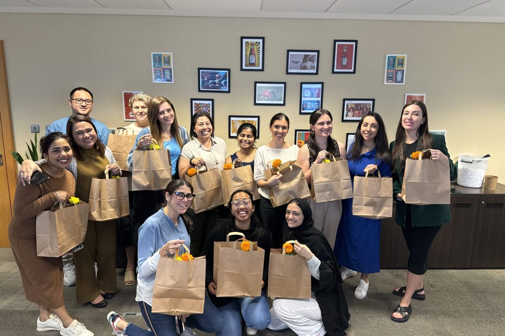 A female group posing with packages after packing stuffs for childrens