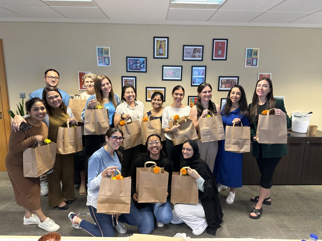 A female group posing with packages after packing stuffs for childrens