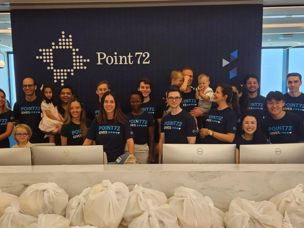 point 72 Dubai employees happly poses while packing food parcels
