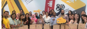 DHL group of people posing happily by packing care parcel