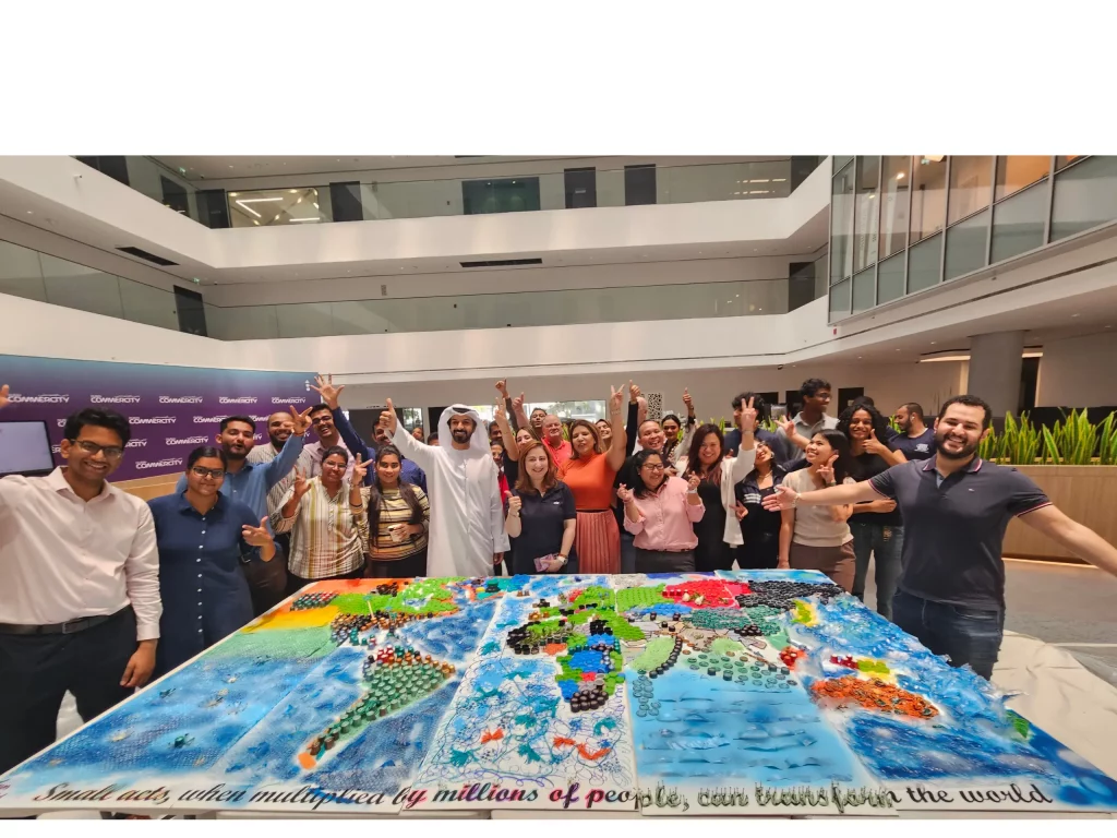 group of people happily raises hands after doing team building activity in dubai