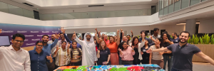 group of people happily raises hands after doing team building activity in dubai