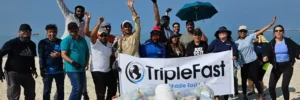 Smiling team at Dubai beach cleanup by TripleFast