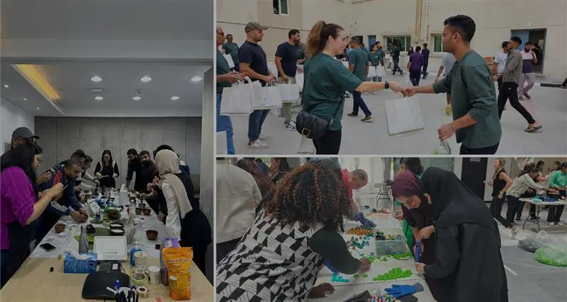 Participants engage in a creative workshop, exchanging ideas and working collaboratively with art supplies on tables.