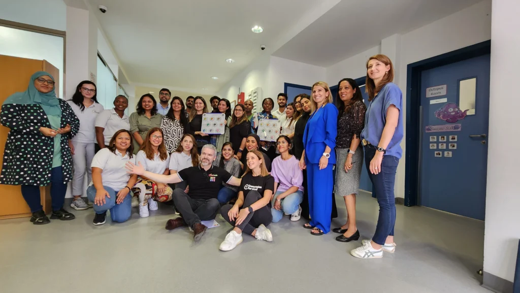 Large group of smiling individuals posing together indoors during a community or team-building event