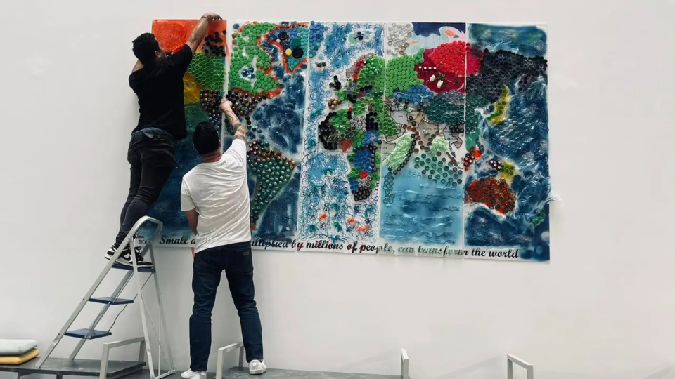 Installing vibrant world map mural on wall
