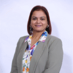 Smiling woman in gray blazer and floral blouse