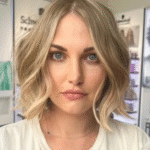 Smiling blonde woman in bright salon setting