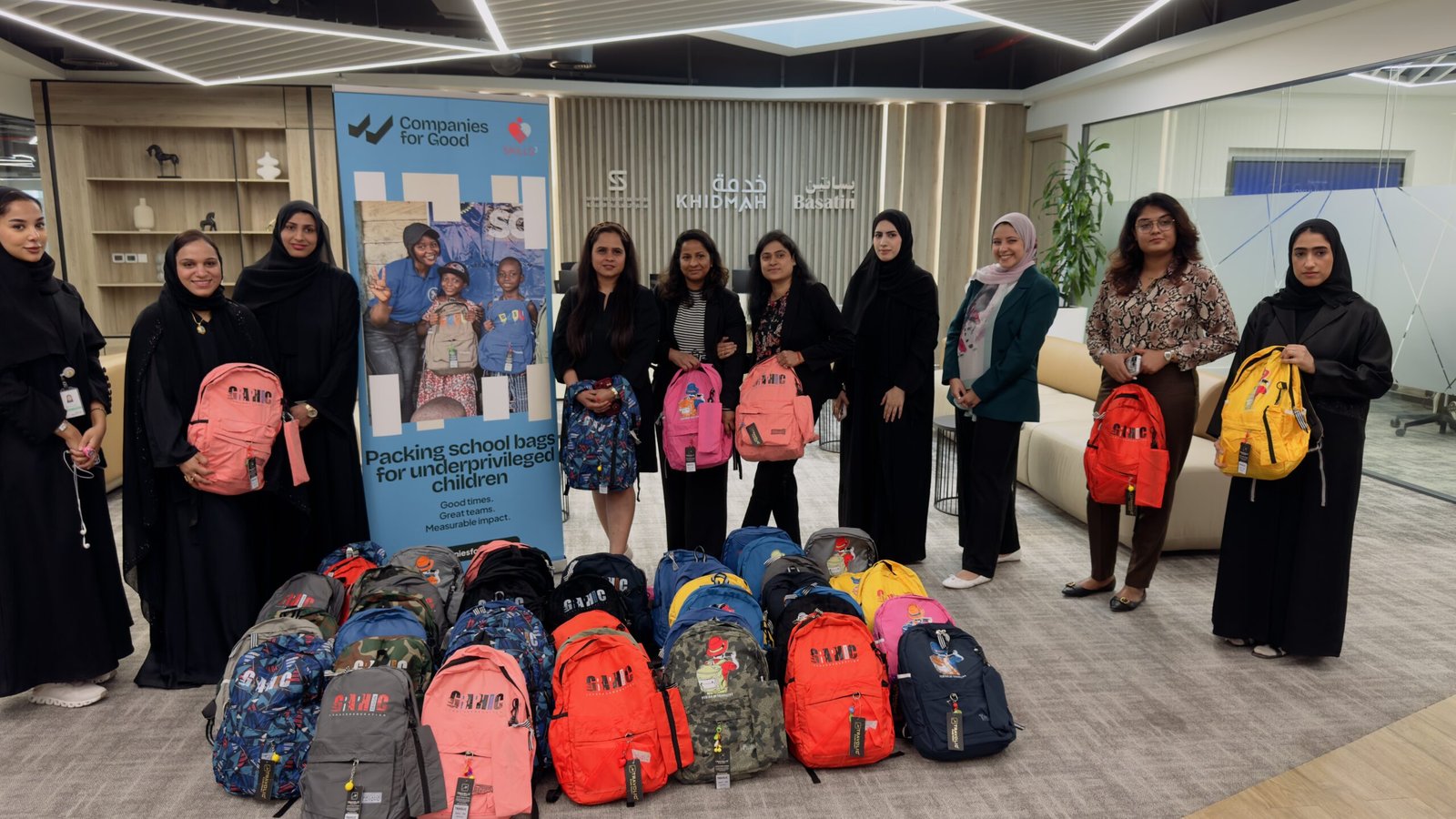 Team packing school backpacks for refugee children